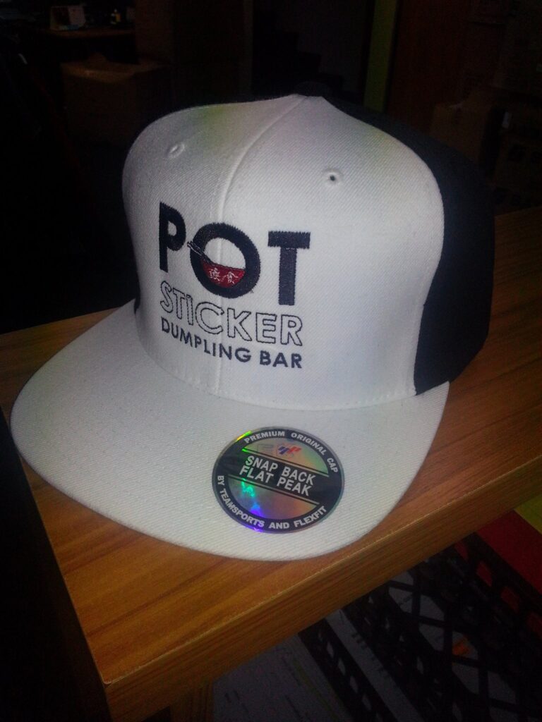 corporate branded snap back cap using embroidery